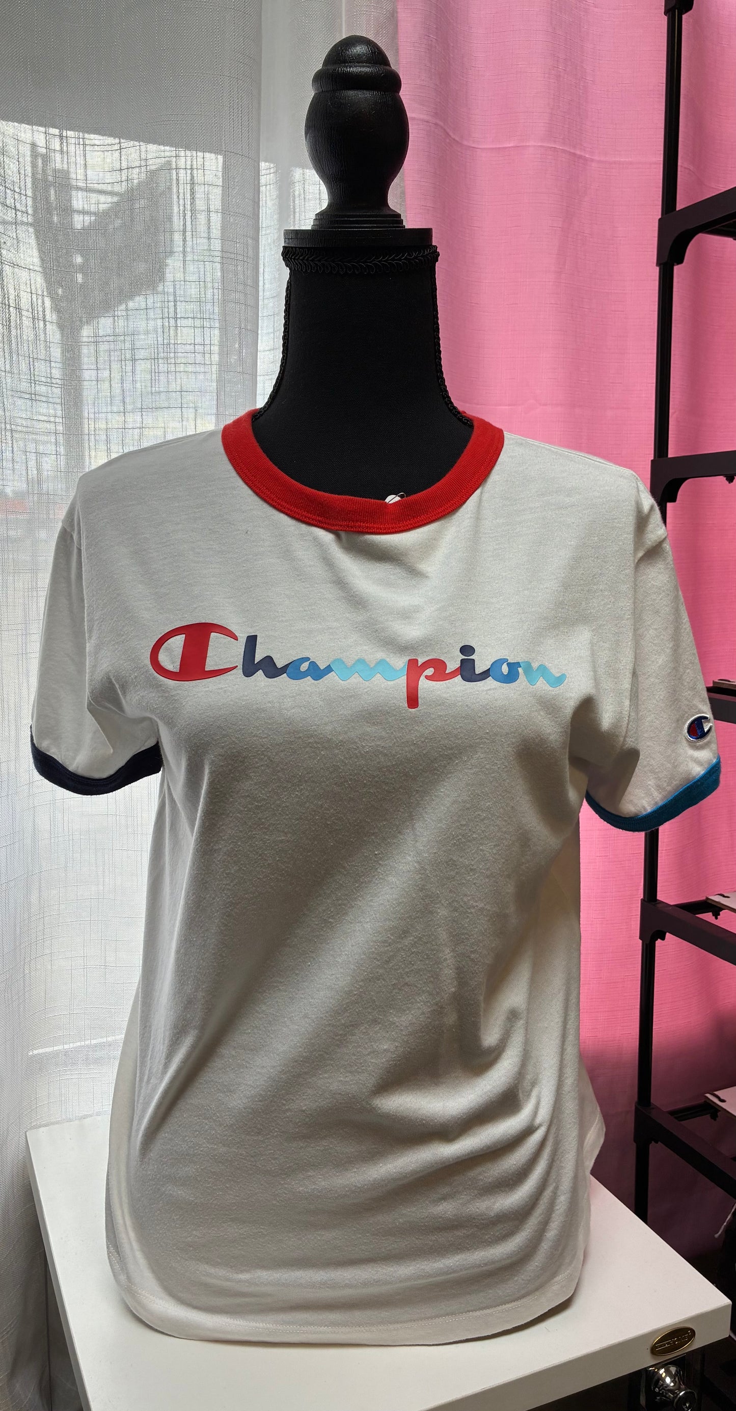 Champion Women's Campus Ringer Tee in white with a red and blue script logo-Size Medium