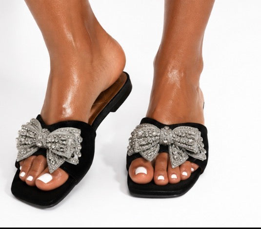 Fashion Nova women’s black and silver slide/mule sandals, size 11, with a large silver rhinestone bow